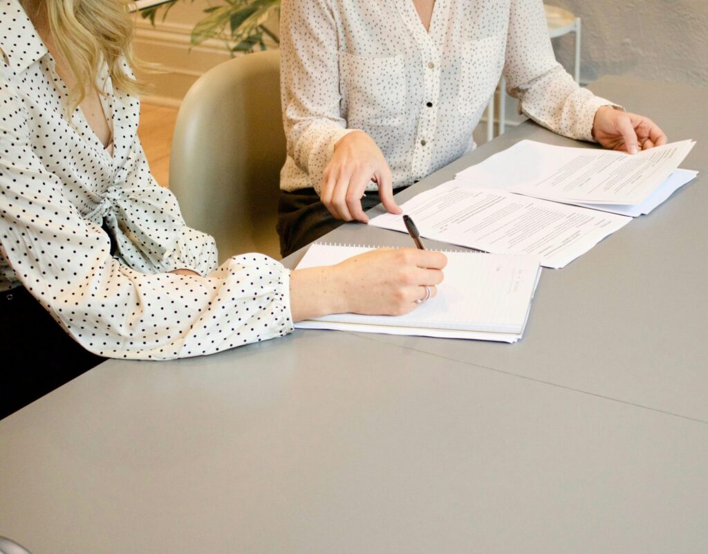 Two people hanging family arrangements paperwork