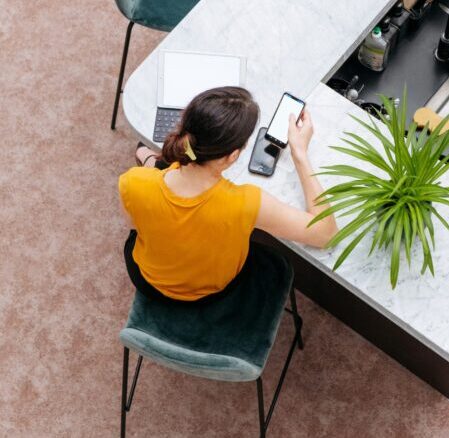 Woman from above at desk reviewing employment agreement