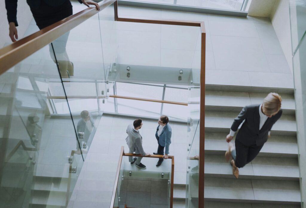 Modern office stairwell with business owners arriving and leaving