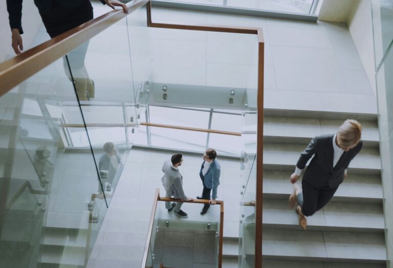 Modern office stairwell with business owners arriving and leaving