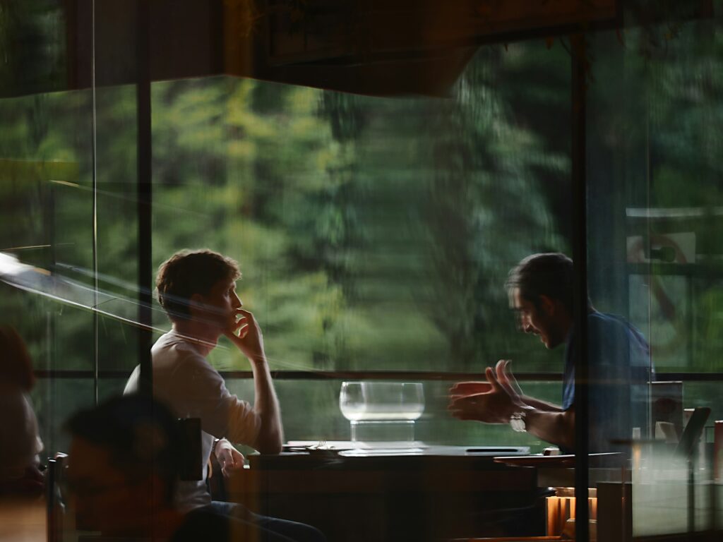 Two people at a table having a company exit deal discussion