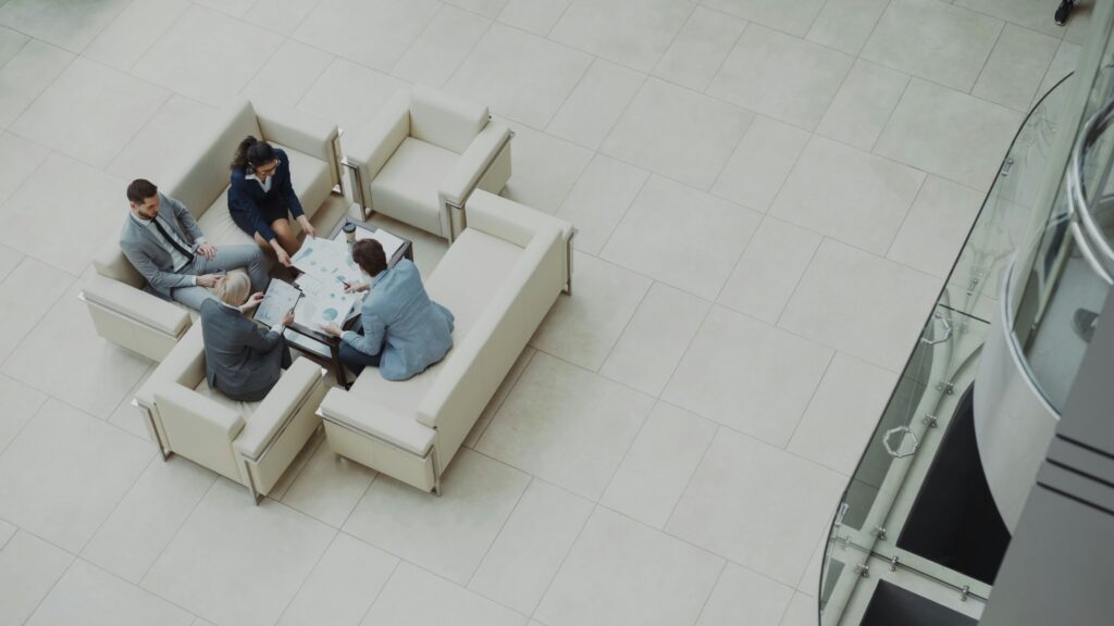 Four people from above on a sofa discussing company structure