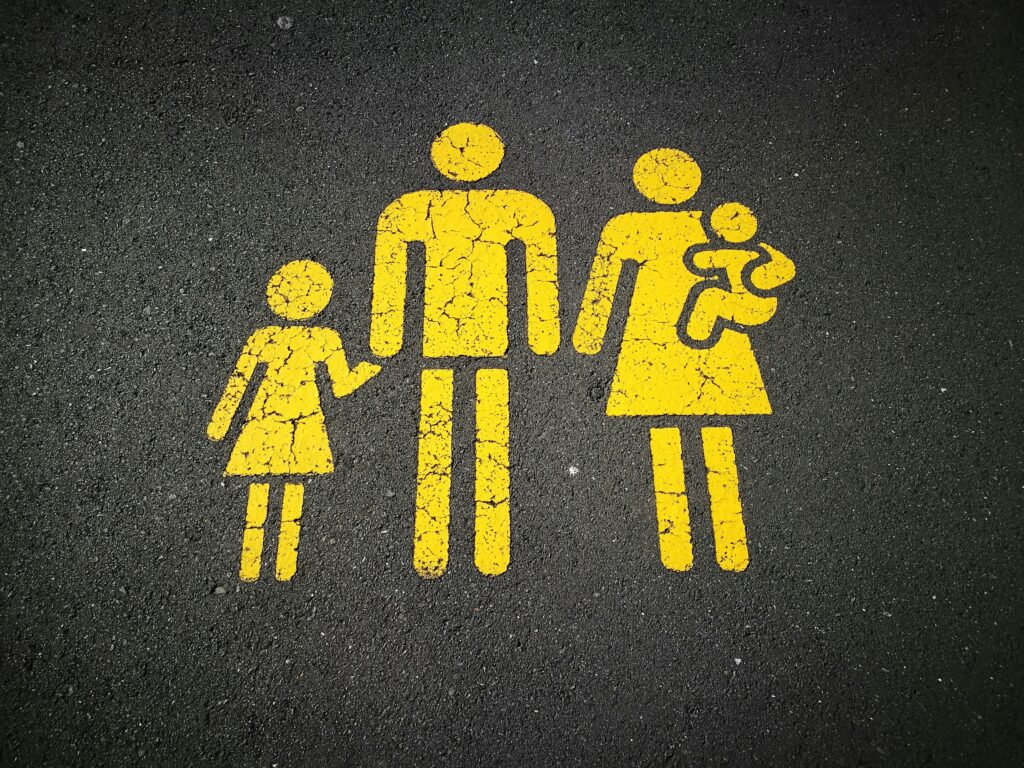 Street sign showing a couple organising children
