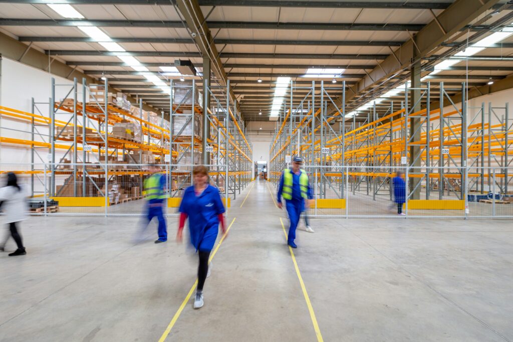 Workers in a warehouse after selling a logistics company
